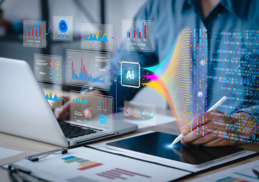 Man siting at a desk with a laptop. Augmented reality of charts and data is displayed.