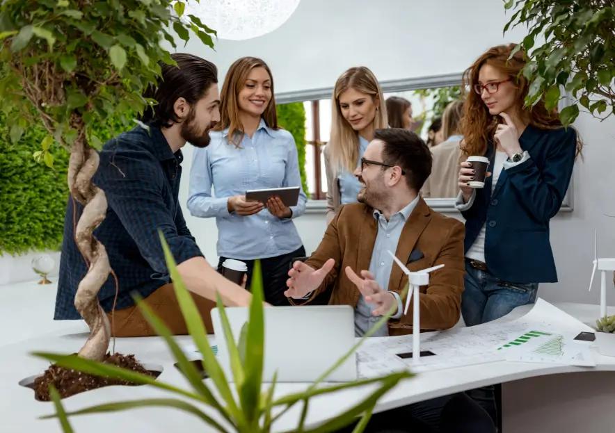 A group of professionals smiling and greeting their client.