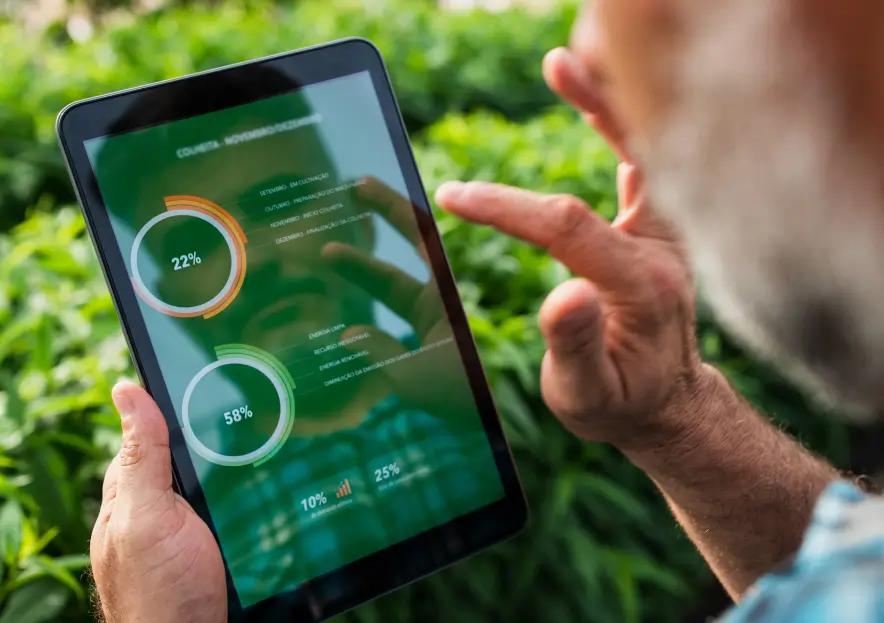 A man using a tablet to analyze pie charts.