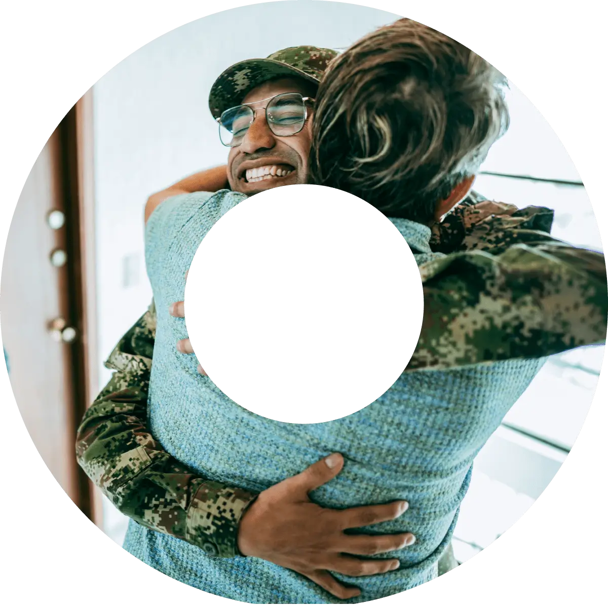 Donut shaped image of a military veteran hugging a family member.