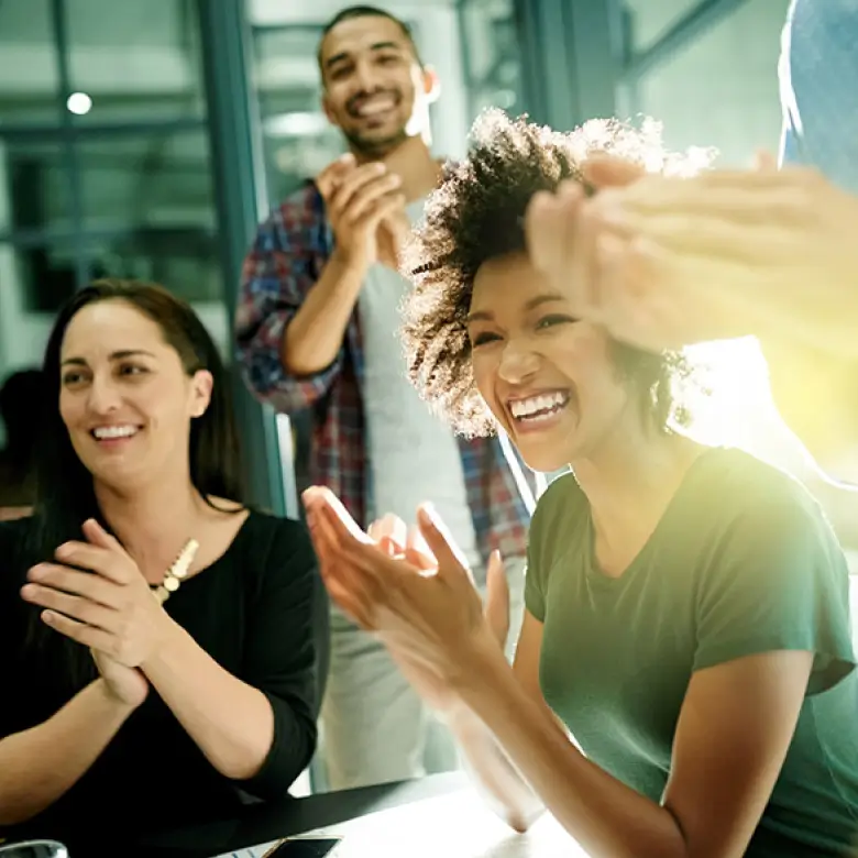 Donut shaped image of diverse professionals clapping and smiling